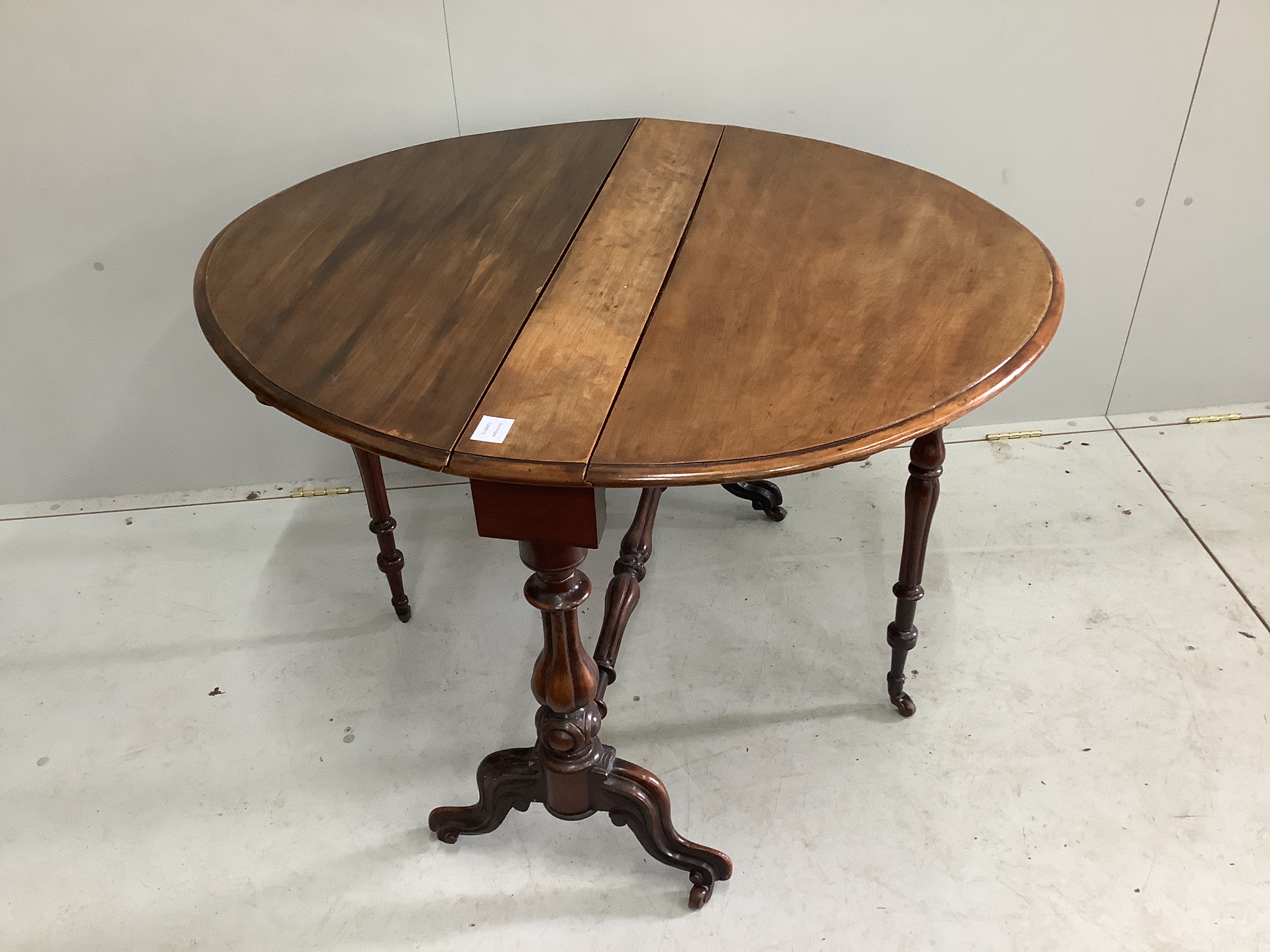 A Victorian walnut oval Sutherland table, width 89cm, height 71cm